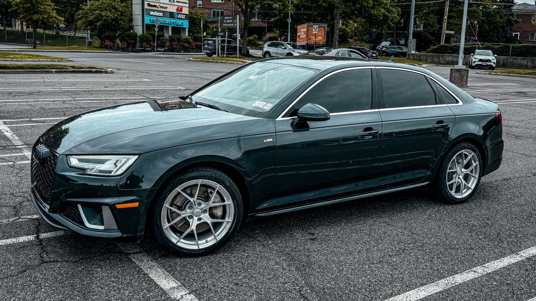 Dark green Audi A4 S-line on forged split five-spoke wheels